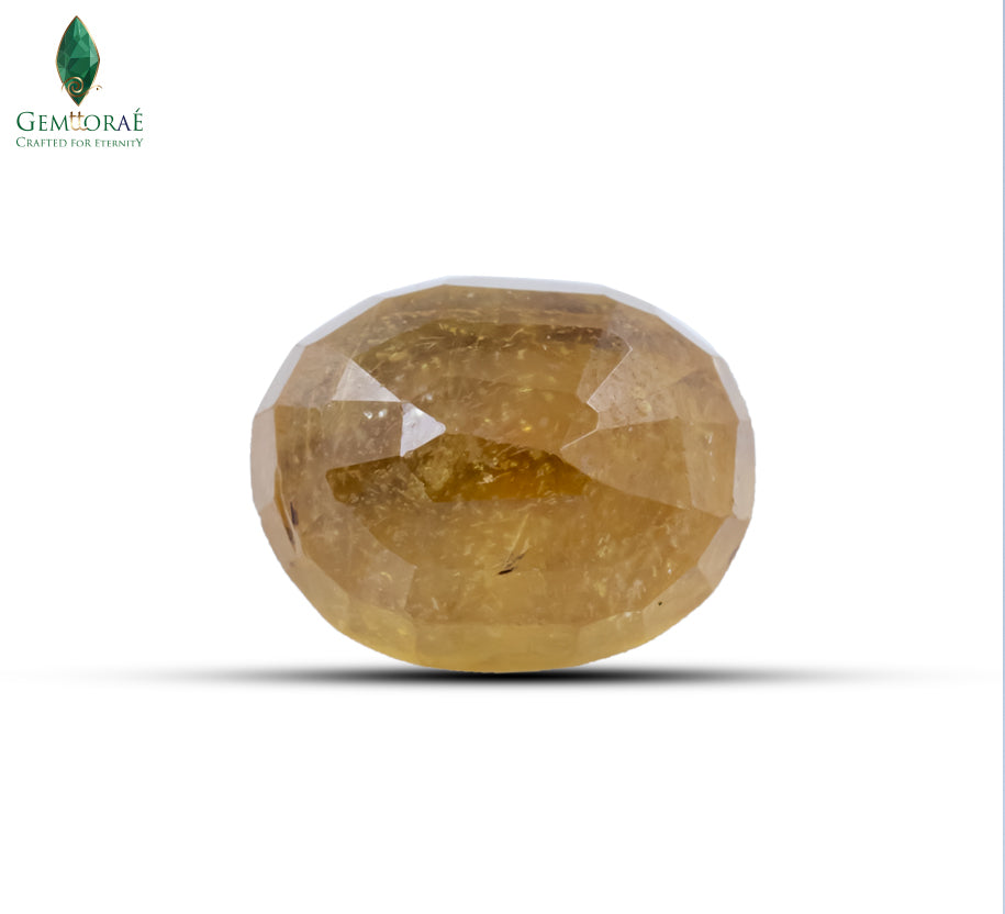 Side view of a glass filled yellow sapphire in an oval cut