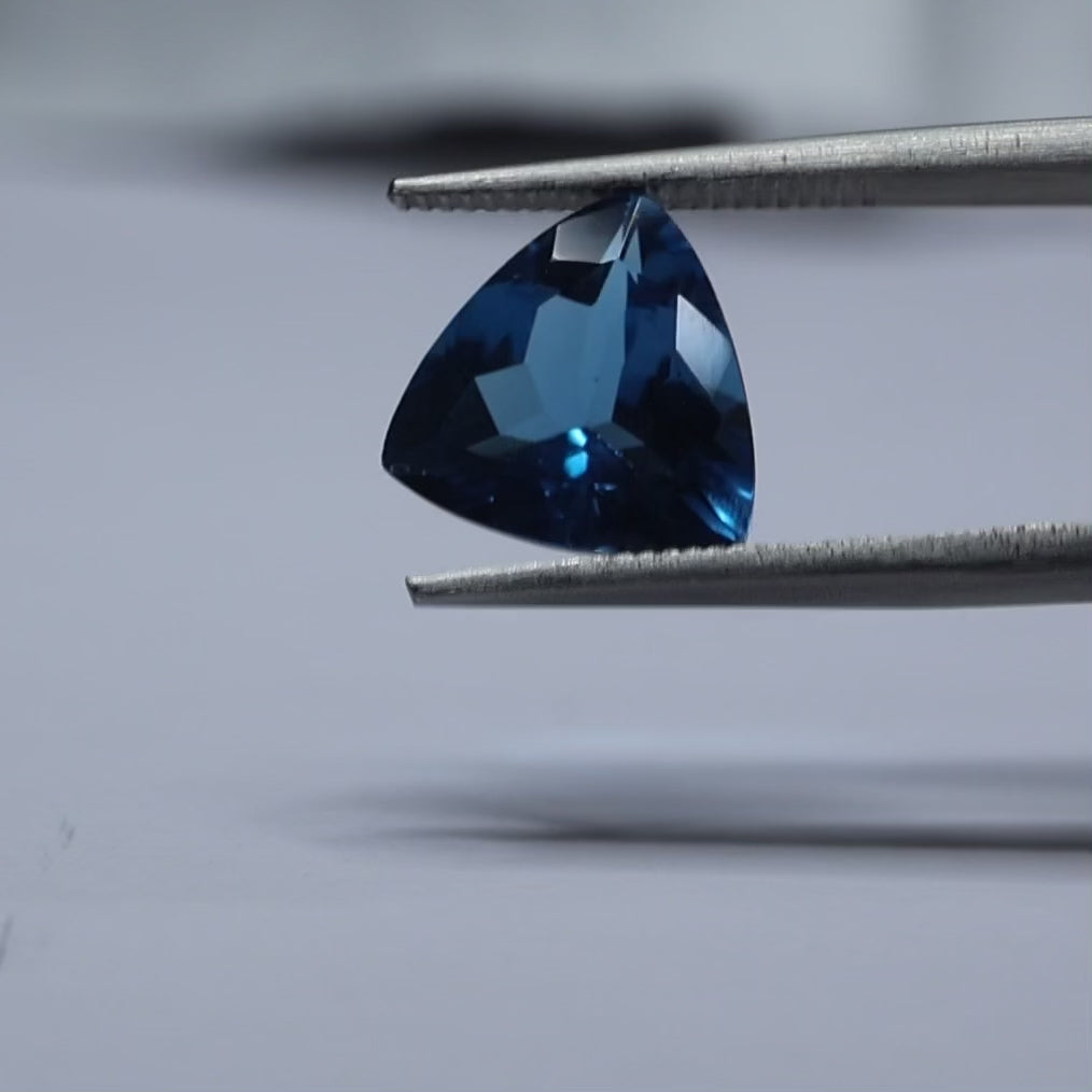 Triangular blue topaz stone with exceptional luster