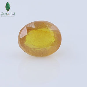Angled view of a faceted yellow sapphire showing polished surfaces